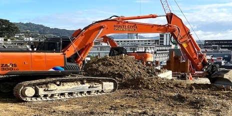 Excavator preparing an earthworks site